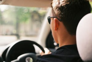Man Driving Car Wearing Black Sunglasses and Shirt
