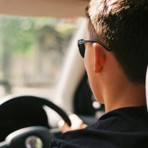 Man Driving Car Wearing Black Sunglasses and Shirt